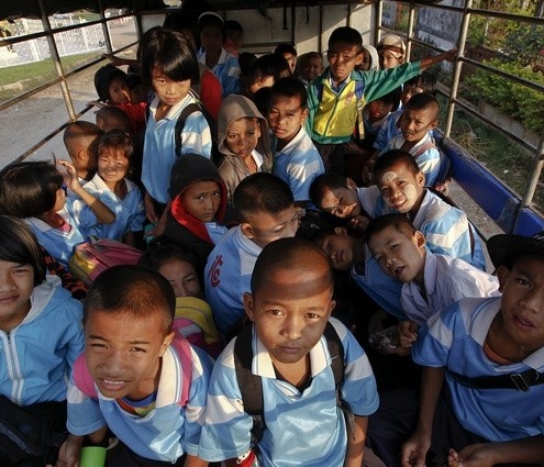 Children-from-Myanmars-Mon-state-ride-on-a-vehicle-to-a-school-on-Thailands-side-of-the-border-with-Myanmar-in-Sangkhlaburi-495x425